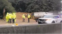  ?? PATRICK TEHAN/STAFF ?? Above: A road worker cleaning up debris from a Highway 17 mudslide was killed after a dump truck backed over him in an apparent industrial accident that injured another crew member in the Santa Cruz Mountains on Thursday.
