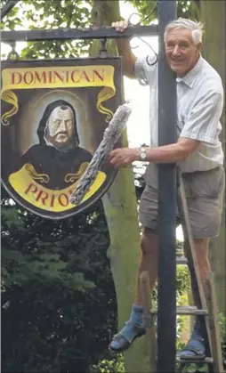  ?? ?? Former window cleaner Don Beerling sprucing up the Dominican Priory sign