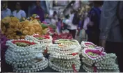  ??  ?? Left: A bustling flower market in India. Right: Jasmine garlands ready to be worn.