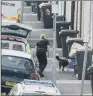  ??  ?? A police sniffer dog searches bins in West Street, Newport, South Wales.