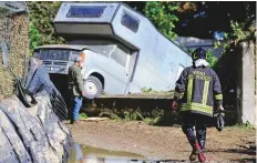  ?? Reuters ?? A fireman walks on a mud covered path in the aftermath of a flood in Casteldacc­ia, near Palermo, Italy, yesterday.