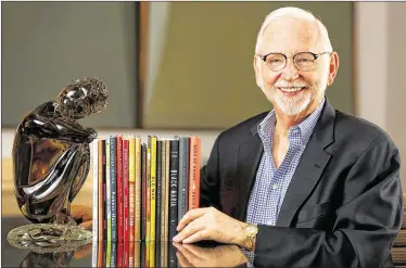  ?? RICHARD GRAULICH / THE PALM BEACH POST ?? Miles Coon worked in the family business for 30 years before going back to school and starting the Palm Beach Poetry Festival in 2005. He’s seen here in his Palm Beach home with books of poetry.