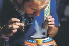  ?? ?? An assistant of Colombian shaman Claudino Perez (not in frame) takes part in a yage or ayahuasca ceremony in La Mesa, Cundinamar­ca department, Colombia.