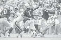  ?? MARK WALLHEISER/AP ?? FSU quarterbac­k James Blackman takes a hit from NC State defensive end Bradley Chubb as he releases a pass in the second half of Saturday’s game.