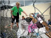  ?? PHOTO: MURRAY WILSON/FAIRFAX NZ ?? Arohanui Hospice Shop co-manager Jennie Lewer with some of the rubbish still being left behind the former hospice shop in Rangitikei St.