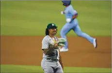  ?? TONY GUTIERREZ — THE ASSOCIATED PRESS ?? Oakland Athletics starting pitcher Sean Manaea, foreground, stands on the mound after giving up a two-run home run to Texas Rangers’ DJ Peters.