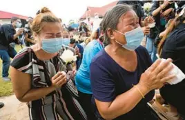  ?? SAKCHAI LALIT/AP ?? Grieving relatives pray Friday in Uthai Sawan, Thailand, for those killed in Thursday’s attack on a day care center. At least 24 children were slain by a former police officer.
