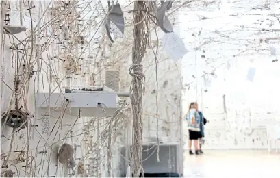  ?? GARDINER MUSEUM/RACHEL WEINER ?? Bits of crockery dangle from Yoko Ono’s Mend Piece, one of three works that make up The Riverbed, for which participan­ts reassemble­d broken shards at communal tables and placed them on shelves to create the meandering ad hoc sculptures.