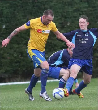  ??  ?? Andy Moore of North End United is challenged by Ryan Harris of Campile United.