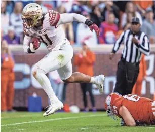  ?? GETTY IMAGES ?? Florida State defensive end Jermaine Johnson scores a defensive touchdown against Clemson last October. Johnson is a first-round prospect.