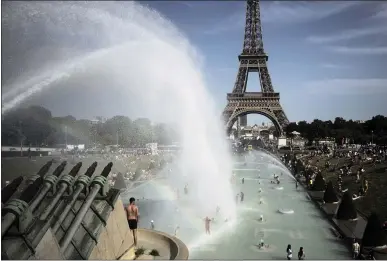  ?? LEWIS JOLY — THE ASSOCIATED PRESS ?? People cool off in the fountains of the Trocadero gardens in front of the Eiffel Tower in Paris on June 28. Temperatur­e records were shattered in Europe and other regions around the globe in June, which was the hottest June with records going back to 1880.