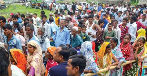  ?? PTI ?? People wait to check their names on the final draft of the state’s National Register of Citizens after it was released, at an NRC Seva Kendra in Tezpur on Monday. —