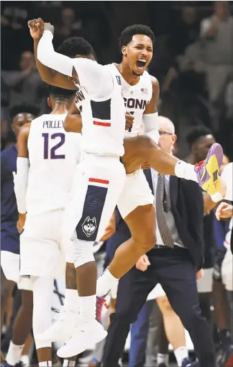  ?? Jessica Hill / Associated Press ?? UConn’s Alterique Gilbert, left, and Jalen Adams celebrate during the first half of Thursday’s game against Morehead State in Storrs.