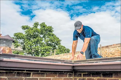  ?? Courtesy of Scott’s Roofing ?? J.R. Baird of Scott’s Roofing inspects a roof in Denver. The Lafayette roofing company recently achieved B Corporatio­n certificat­ion, becoming the only roofing company in the country with that certificat­ion.