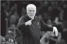  ?? STEVEN SENNE/AP PHOTO ?? San Antonio Spurs head coach Gregg Popovich points from the bench in a game against the Boston Celtics on March 26 in Boston.