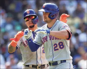  ?? Ronald Martinez / Getty Images ?? The Mets’ Javier Baez, left, and J.D. Davis celebrate after scoring against the Dodgers in the seventh inning Sunday in Los Angeles.