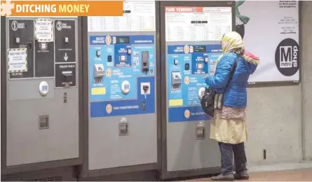  ?? — AFP ?? A Metrorail commuter uses a fare machine at a station in Washington, DC.