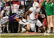  ?? Reed Hoffmann/Associated Press ?? Texas running back Bijan Robinson, right, rushed 30 times for 209 yards and a touchdown.