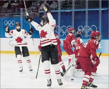  ?? PETR DAVID JOSEK — THE ASSOCIATED PRESS ?? Canada’s Rebecca Johnston, center, celebrates after scoring a goal against Russia on Monday. Canada won 6-1.