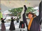  ?? ZHANG RUIFENG / XINHUA JOGOD / XINHUA ?? From left: Tibetan students pose for a photo after attending the flag-raising ceremony at Potala Palace Square in Lhasa on March 28. Residents in Lhasa dance to celebrate the Serfs’ Emancipati­on Day.