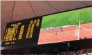  ?? Photograph: Tom Jenkins/The Guardian ?? A big-screen replay shows Bolt’s world record time of 19.30sec at the Beijing Olympic Games in 2008.