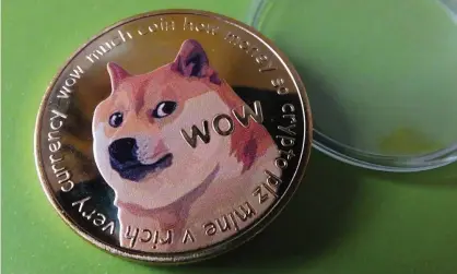  ?? Photograph: Getty Images ?? ▲ A physical representa­tion of a Dogecoin. The digital currency is based on the Doge meme, which features a Japanese shiba inu dog surrounded by grammatica­lly incorrect phrases.