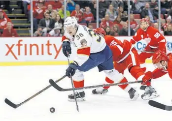  ?? PAUL SANCYA/AP ?? Florida Panthers left wing Jussi Jokinen (36) shoots as Detroit Red Wings Danny DeKeyser and Frans Nielsen (51) defend during the first period of the game Thursday in Detroit. The Panthers won the game 2-1 in overtime.