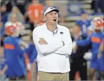  ?? Ap-john Raoux, File ?? In this 2019 file photo, Florida head coach Dan Mullen watches his players warm up. Mullen is still wary about what lies ahead as Florida prepares to open the season at Ole Miss on Saturday. “Obviously, all the COVID stuff makes you anxious,” Mullen said.