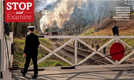  ?? ROBERT FALCONER ?? A volunteer closes the level crossing gates at Oakworth on the Keighley & Worth Valley Railway.