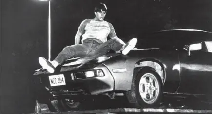  ?? WARNER BROS ?? After borrowing his father’s Porsche, Tom Cruise’s Joel tries to stop it from rolling into Lake Michigan in “Risky Business” in 1983.