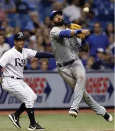  ?? CHRIS O’MEARA/THE ASSOCIATED PRESS ?? Jays third baseman Jose Bautista leaves his feet but can’t throw out Tampa Bay Rays’ Wilson Ramos at first on an RBI single in the fifth inning.