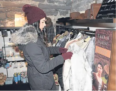  ?? Picture: David Mcnie. ?? Katie Gater picks out one of the period-style Outlander dresses available to the public wanting to emulate their screen favourites at Doune Castle.