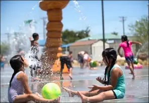  ?? VINCENT OSUNA PHOTO ?? Jeanna Zermeño, 7, (right) and her friend play in the splash pad at Alyce A. Gereaux Park in Brawley on Saturday afternoon.