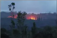  ?? CALEB JONES — THE ASSOCIATED PRESS ?? Lava shoots into the night sky from active fissures on the lower east rift of the Kilauea volcano, Tuesday near Pahoa, Hawaii.