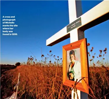  ??  ?? A cross and photograph of Michelle marks the site where her body was found in 1999.