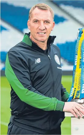  ?? Picture: SNS. ?? Rival managers Brendan Rodgers of Celtic and Stephen Robertson of Motherwell both got their hands on the Scottish Cup last week.