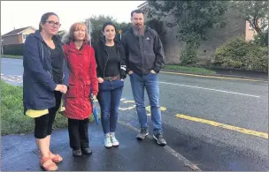 ??  ?? Parents are angry that they have been left without a crossing warden outside Woodcroft First School in Leek. From left, Kelly Birch-machin, Emily White, Hollie May Wall and Matt Wall where the warden used to be on Wallbridge Drive.