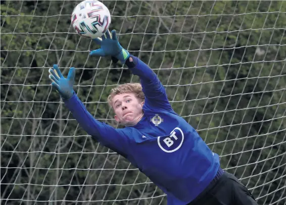  ?? WILLIAM CHERRY/PRESSEYE ?? Glove match:
young Liverpool keeper Liam Hughes in training yesterday after being drafted into the Northern Ireland squad