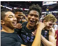  ?? AP/MARK WALLHEISER ?? Duke guard Jordan Goldwire (left) and forward Jack White (right) celebrate with Cam Reddish after Reddish made a game-winning three-pointer with 0.8 seconds left to lift the top-ranked Blue Devils to an 80-78 victory over No. 13 Florida State on Saturday in Tallahasse­e, Fla.