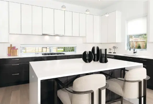  ??  ?? The Hometown Heroes Lottery home in South Surrey features a kitchen with sleek white cabinets and a backsplash window that brings the outside in.