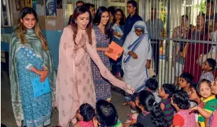  ?? PTI ?? founder and chairperso­n of Reliance foundation Nita Ambani, along with her daughter isha Ambani and Shloka Mehta, interacts with the children and old age people during a visit to the Asha Daan Missionari­es of Charity in Mumbai on friday. —