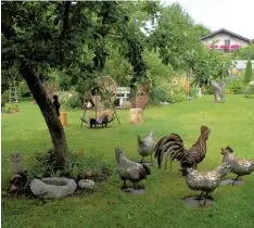  ?? Fotos: Romi Löbhard ?? Masken aus Holz, Fußball spielende Kinder, Hühner samt Gockel aus Metall und schönes Flechtwerk – all das und noch viel mehr gibt es im Garten des Ehepaares Bichler in Greifenber­g zu entdecken.