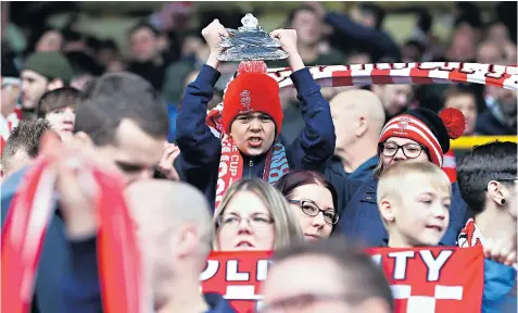  ??  ?? A jubilant young fan of Lincoln City shows what it means to beat Burnley and reach the last eight of the FA Cup, a feat not achieved by a non-League club for more than a century