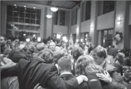  ?? AUDRA MELTON, NYT ?? Supporters of Roy Moore, the Republican candidate for U.S. Senate, pray at an election night gathering in Montgomery, Ala., Dec. 12.