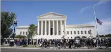  ??  ?? People gather at a makeshift memorial to honour Ginsburg in front of the US Supreme Court yesterday in Washington, DC.