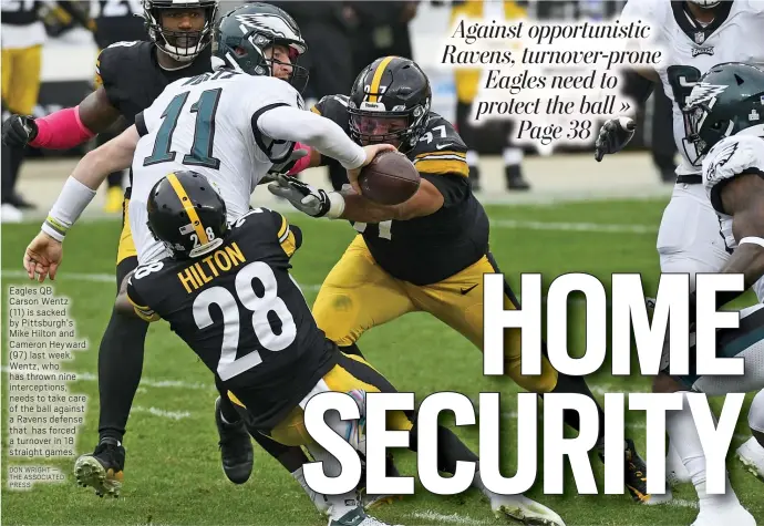  ?? DON WRIGHT — THE ASSOCIATED PRESS ?? Eagles QB
Carson Wentz
(11) is sacked by Pittsburgh’s Mike Hilton and Cameron Heyward
(97) last week. Wentz, who has thrown nine intercepti­ons, needs to take care of the ball against a Ravens defense that has forced a turnover in 18 straight games.