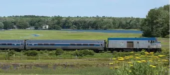  ?? PHoto courtesy amtrak ?? ON THE RAILS: The Amtrak Downeaster crosses past verdant fields.