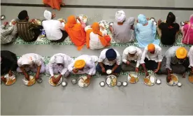  ??  ?? A langar or communal meal in a Sikh temple in Nanded, India. Photograph: Dinodia/