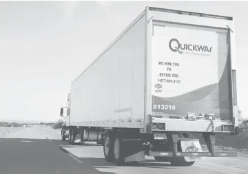  ??  ?? A Quickway Transporta­tion Inc. tractor trailer travels on a road near Davis, Oklahoma, in 2014. Truck cargo data is a reliable predictor of future economic activity, with a steady string of monthly freight declines preceding each of the past five US...