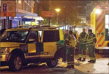  ??  ?? Chaos: Paramedics and police outside Bedford Prison last night as pictures emerged of inmates apparently running riot inside